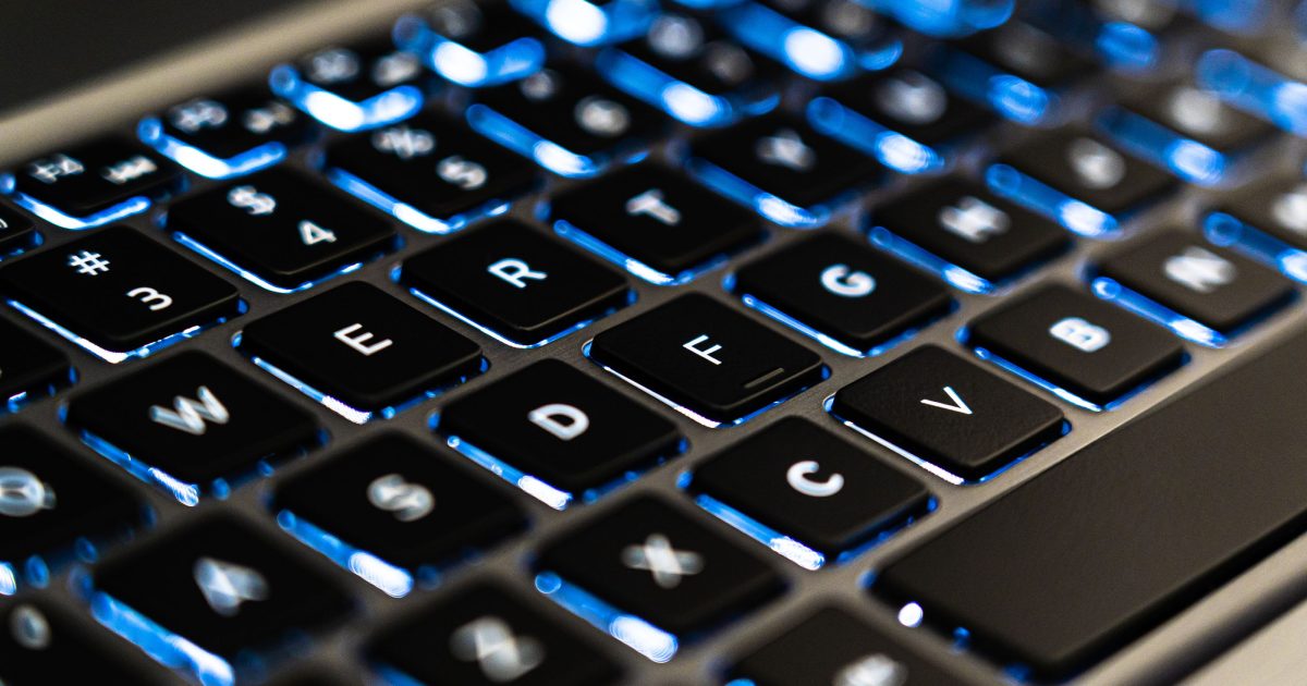 Close-up of a backlit laptop keyboard
